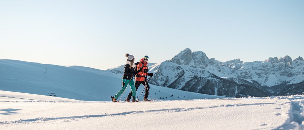 Current news and stories from Olang Two people snowshoe hiking in front of snowy mountains
