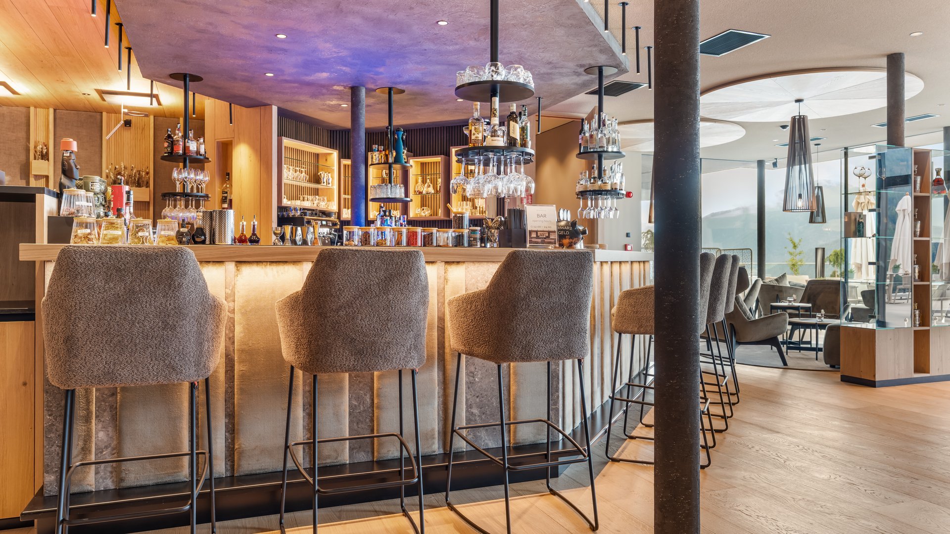 A place to enjoy Modern hotel bar area with high stools and illuminated counter