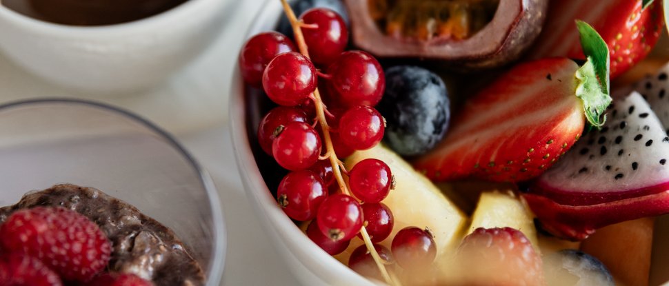 Our 5-star hotel in Italy between heaven and earth Bowl of fresh fruit, chia pudding, and chocolate on white table