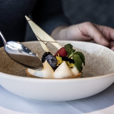 The best hotel at Plan de Corones/Kronplatz Elegant dessert with berries and cream on a white plate