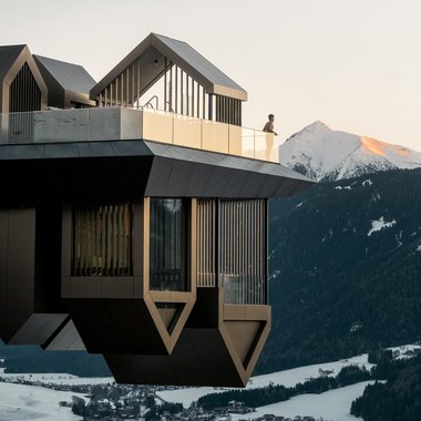 Awards & Press Modern viewing platform with mountain view and a person leaning on the railing