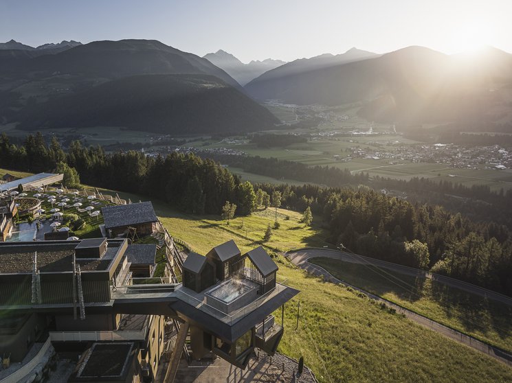 Heaven & hell, our new highlight Mountain panorama with modern building and rising sun in the valley