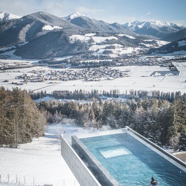 Certified quality for you Heated pool with snowy mountains and forest in winter background