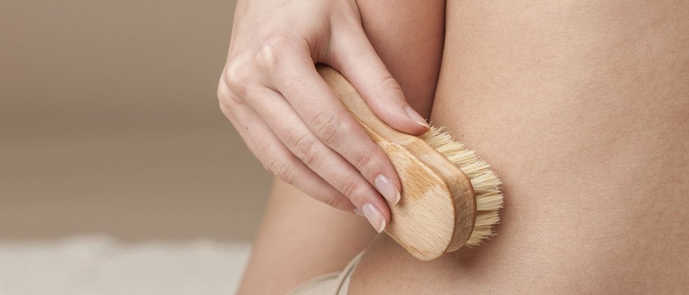 Current news and stories from Olang Hand holding dry brush exfoliating skin on body